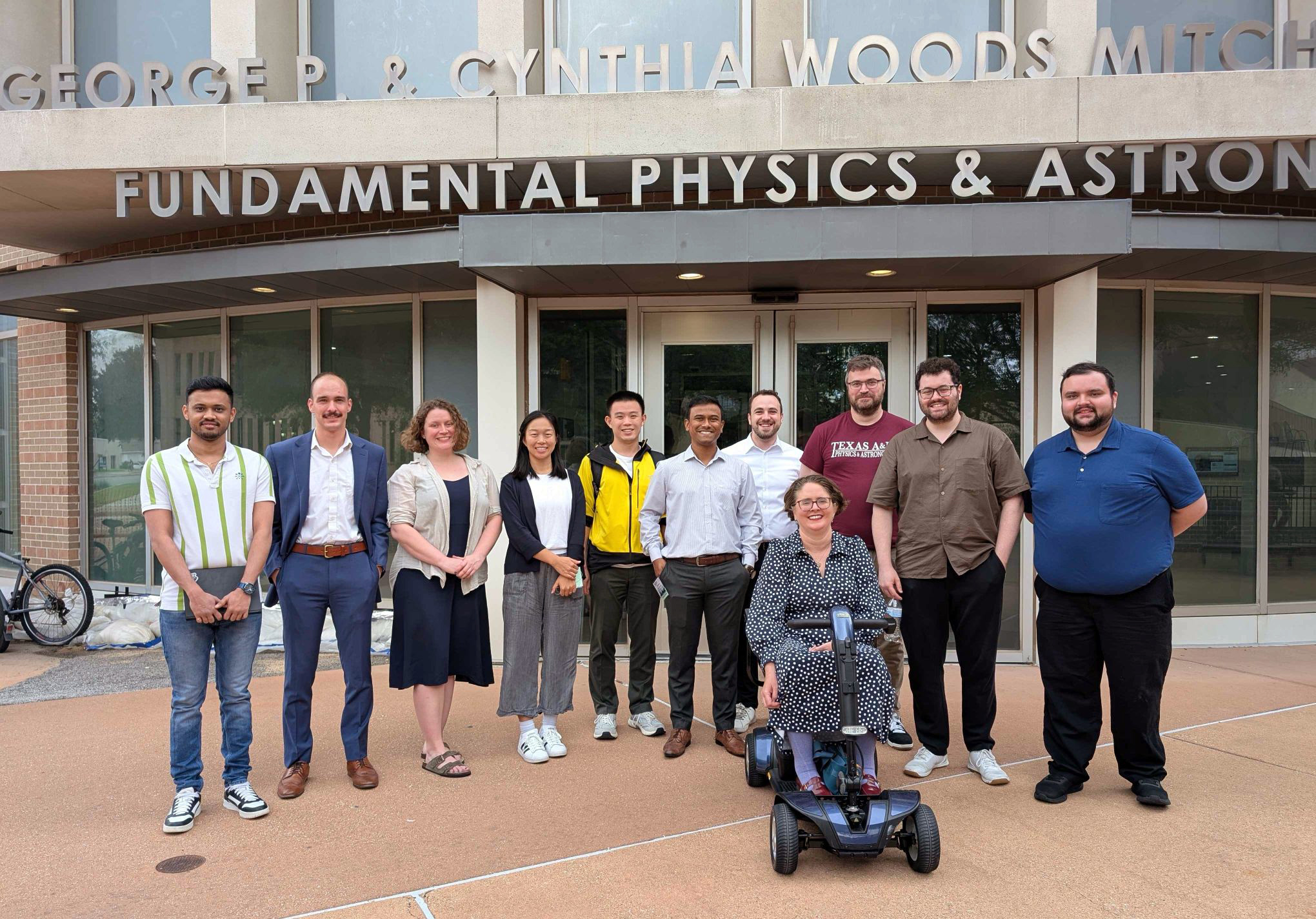 (From left:) CeNAM Frontiers 2026 planning committee members Guruprasad Yagadevan (Politechnika Wrocławska), Anthony Lestone (Texas A&M University), Kelsey Lund (University of California, Berkeley), Mengke Li (University of California, Berkeley), Ruijie "Jay" Shi (University of Florida), Muhammad Asif Zubair (Mississippi State University), David Friedenberg (Texas A&M University), Dr. Jennifer Marshall (Texas A&M University), Dr. Philip Adsley (Texas A&M University), Guilherme Limberg (University of Chicago) and John Dixon (Texas A&M University) pose during a break in the conference outside the George P. and Cynthia Woods Mitchell Institute for Fundamental Physics and Astronomy.